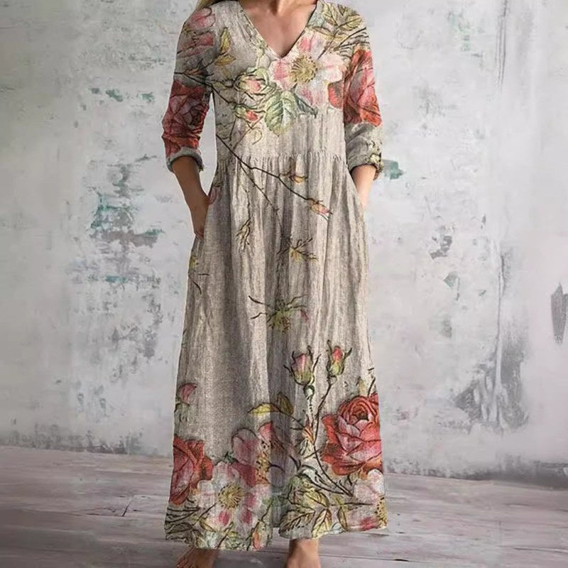 Elegant v-ringad maxiklänning med blommönster och långa ärmar - Floral